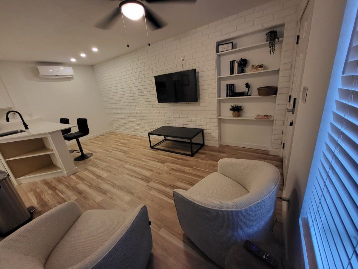 Furnished living area with seating and TV